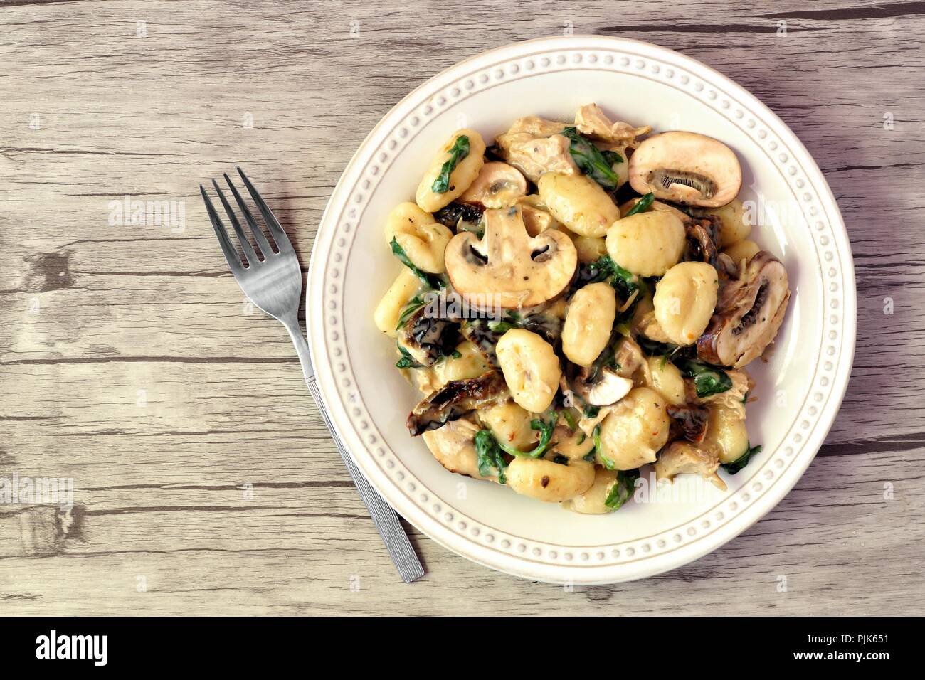 Gnocchi with a mushroom cream sauce, spinach, chicken and sun dried