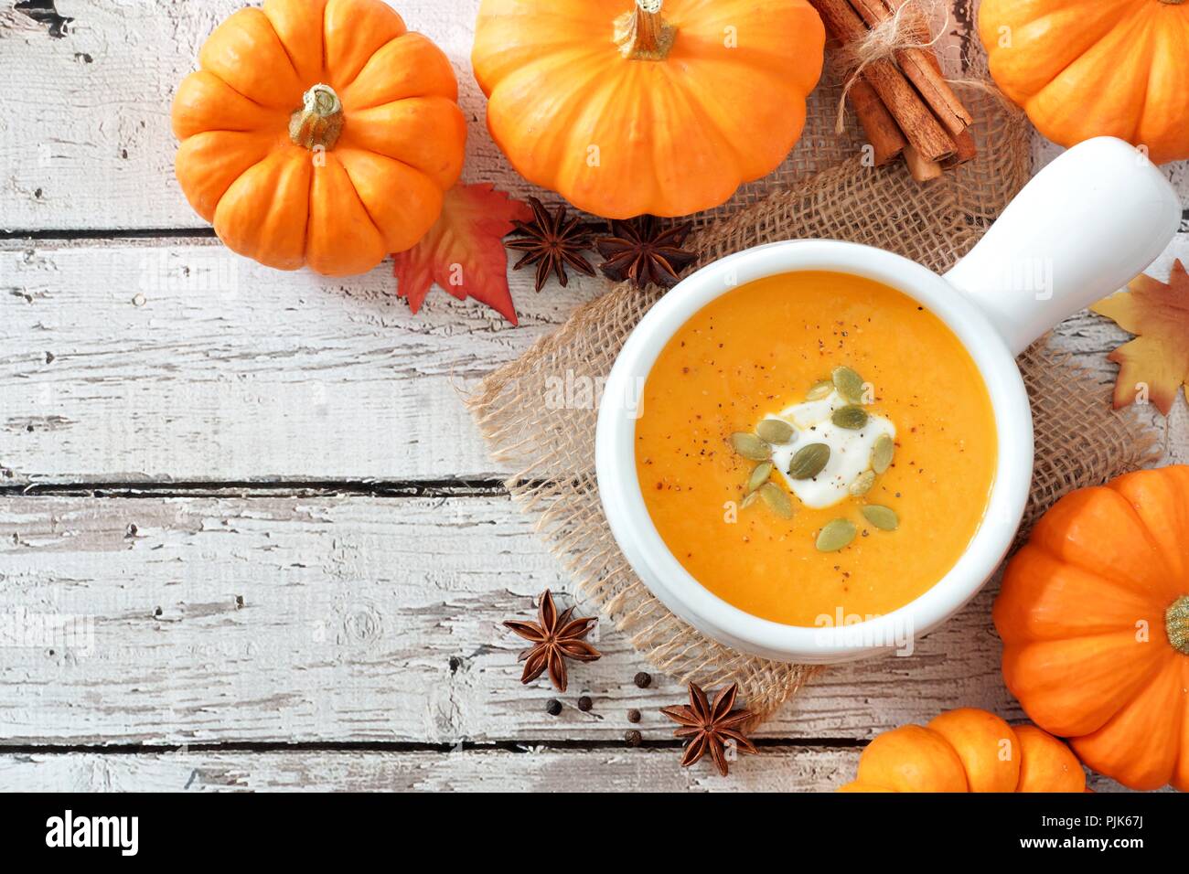 Pumpkin soup on white wood background Stock Photo - Alamy