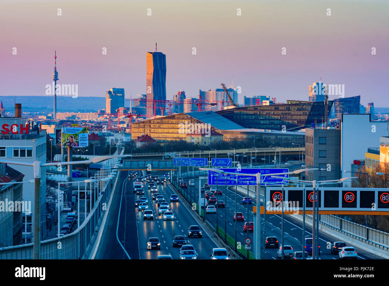 Wien, Vienna, Motorway A23 (Südosttangente), view of the T-Mobile-Center of T-Mobile Austria and T-Systems Austria in the district of St. Marx and on the office towers of the Donaucity with DC Tower 1 and Donauturm in the background, light track of cars in Austria, Wien, overview Stock Photo