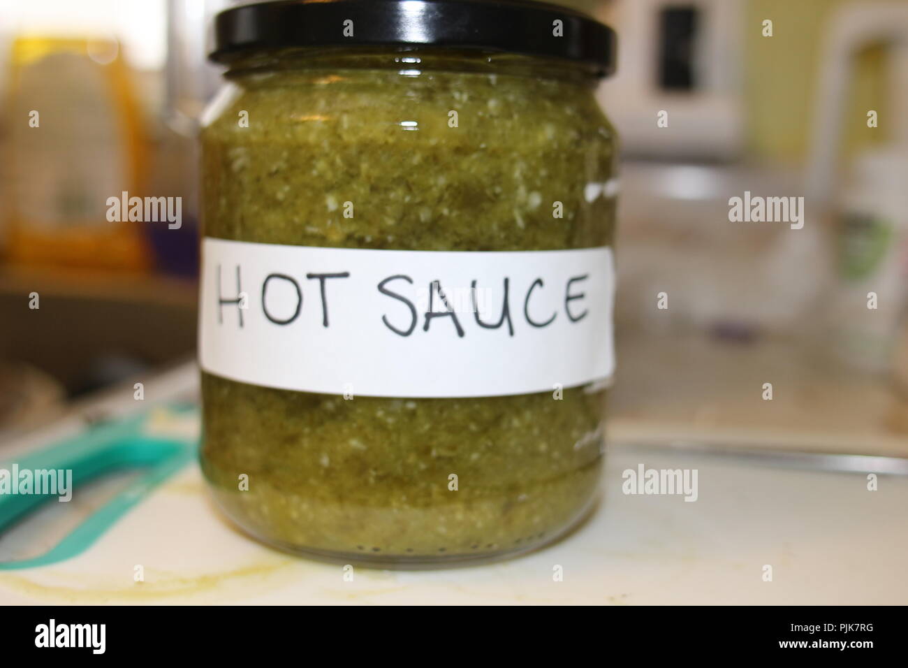 Homemade green hot sauce with a label on it Stock Photo Alamy