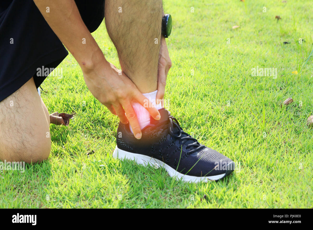 The man has hurt at the ankle / ankle hurt Stock Photo