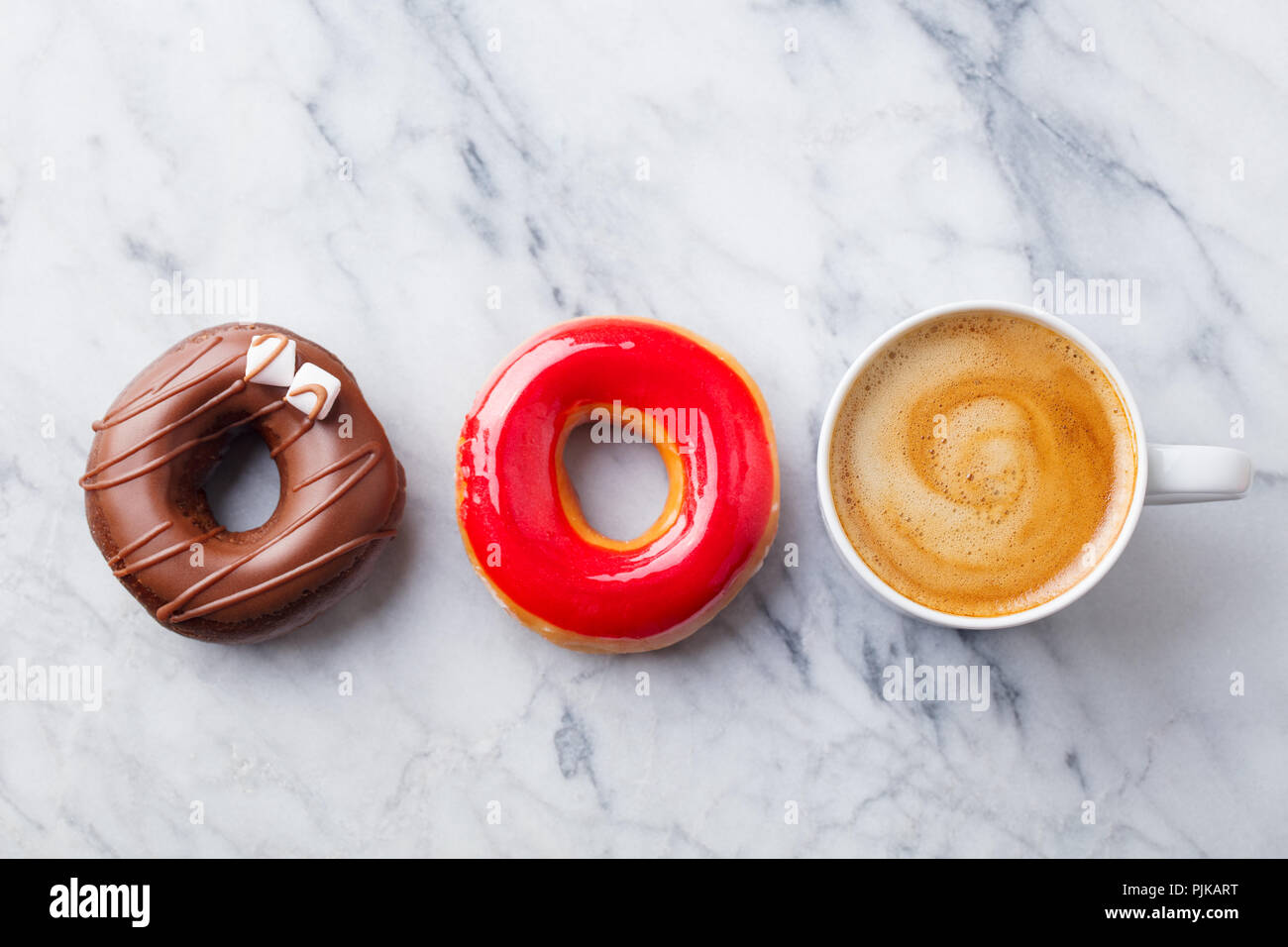 Coffee with donuts on marble table background. Copy space. Top view Stock Photo
