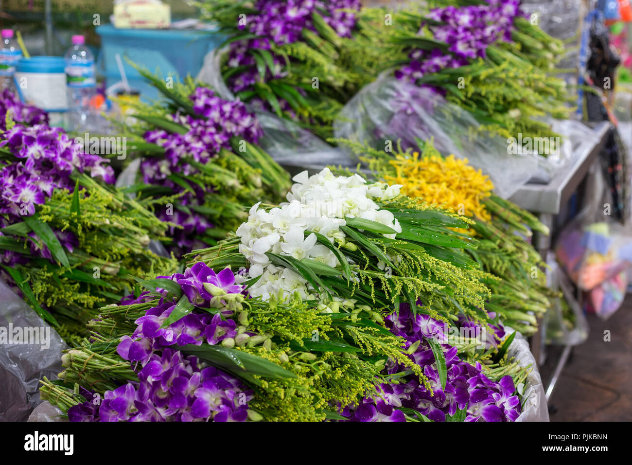 Stacks of fresh flowers for sale at the Yodpiman Flower Market (also