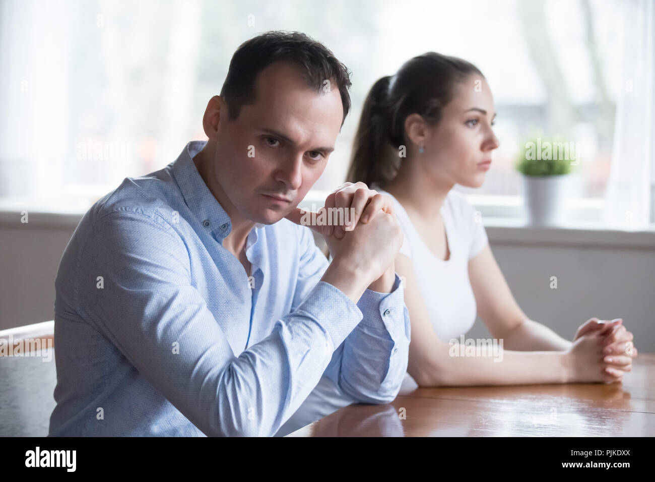 Stubborn couple avoid talking to each other after fight Stock Photo