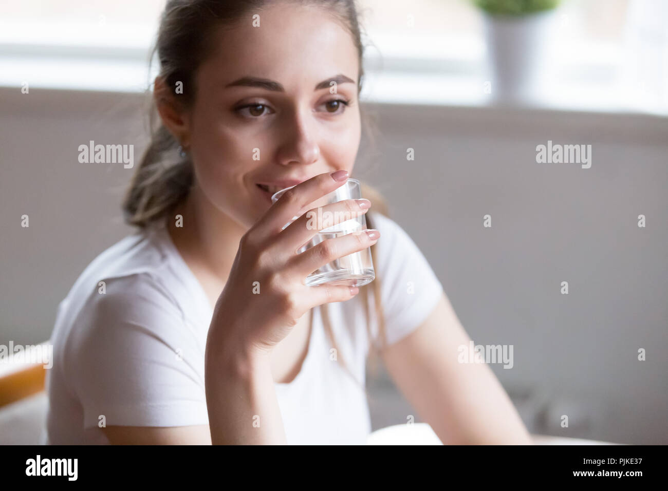 Dehydrated woman is drinking pure mineral water Stock Photo