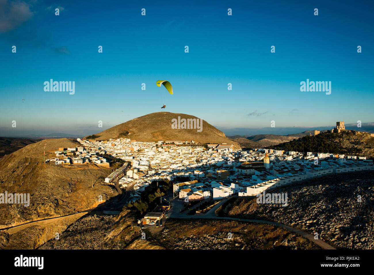 White old town and castle of Teba in Andalusia with paraglider, aerial view, Malaga province, Spain Stock Photo