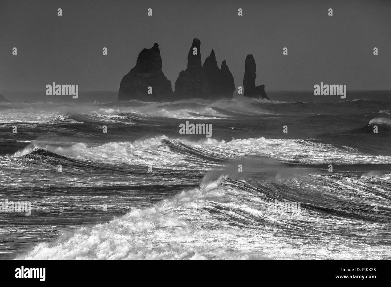 Reynisdrangar, black cliffs at Vik in stormy sea, white waves Stock Photo