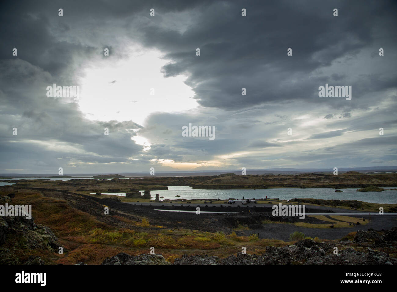 Iceland, Lake Myvatn, evening sun lake, backlight, cloudy sky with big cloud hole, autumnal mood Stock Photo