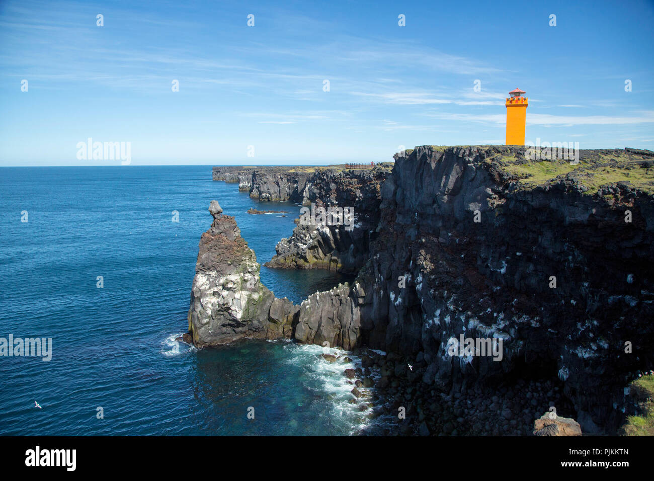 Iceland, Snaefellsness peninsula, yellow lighthouse at Hellissandur, black cliffs, Stock Photo