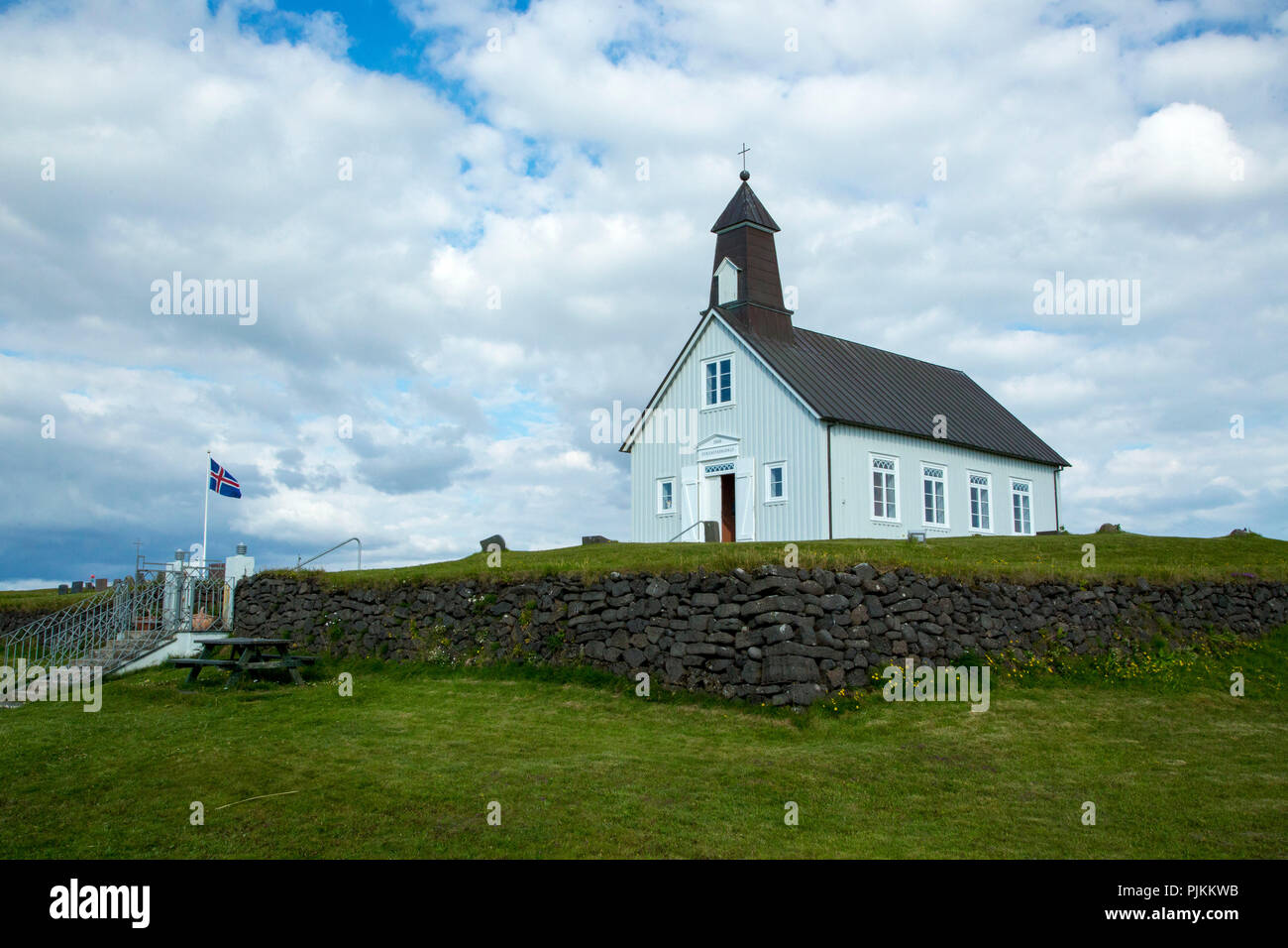 Iceland, Reykjanes peninsula, Strandarkirka, Icelandic flag, stone wall Stock Photo
