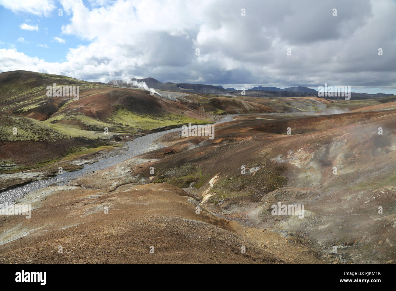 Iceland, rhyolite mountains, river, hot springs, steam clouds, high