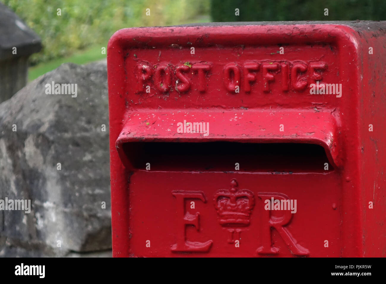 closeup of a letterbox slot in a Red Royal Mail Post box In the middle