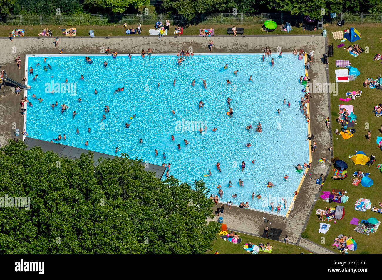 Outdoor pool Dellwig at Rhein-Herne-Kanal, outdoor pool, sunbathing area with sunbathers, summer, Essen, Ruhr area, North Rhine-Westphalia, Germany Stock Photo