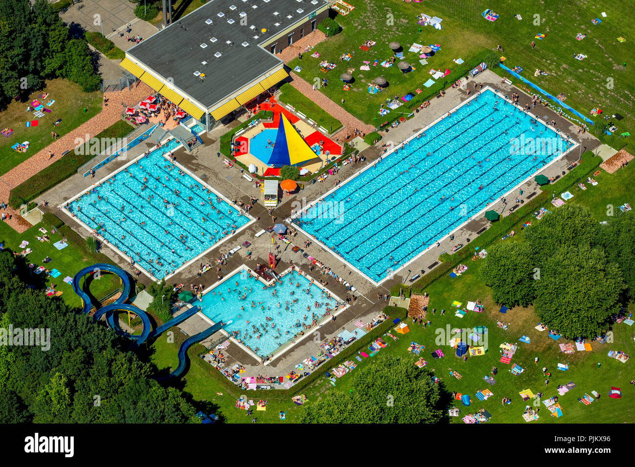 Outdoor pool south with swimming pool, non-swimming pool, bathers, sunbathing areas, waterslide, summer, Hamm, Ruhr area, North Rhine-Westphalia, Germany Stock Photo