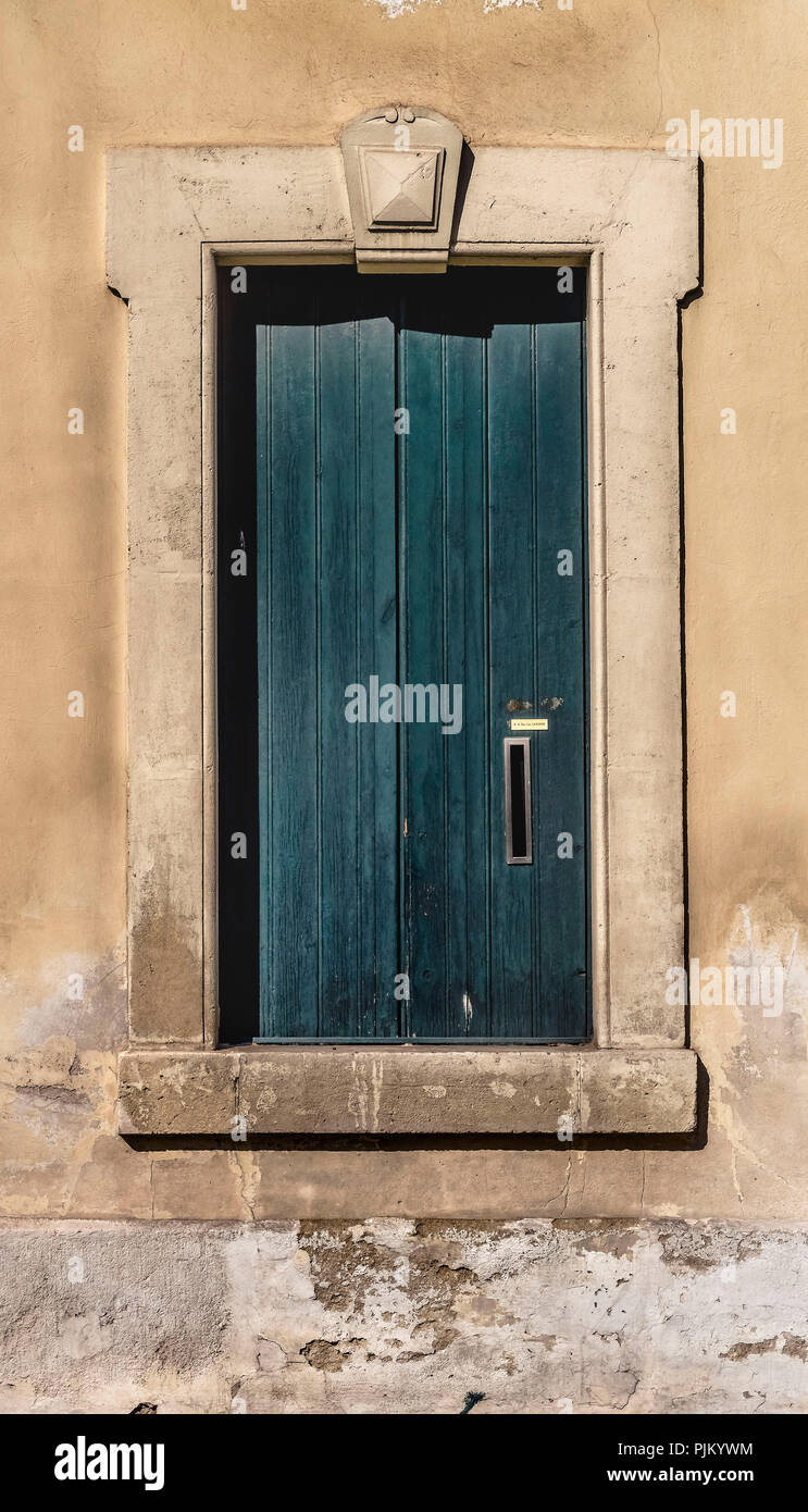 Old wooden shutter with letter slot in Narbonne Stock Photo