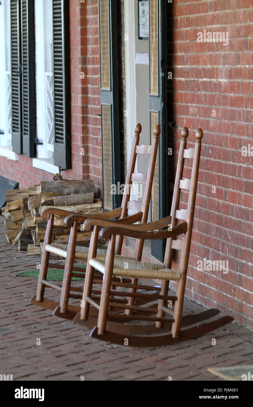 Charlottesville, VA, USA. Rocking chairs and firewood outside dorms at