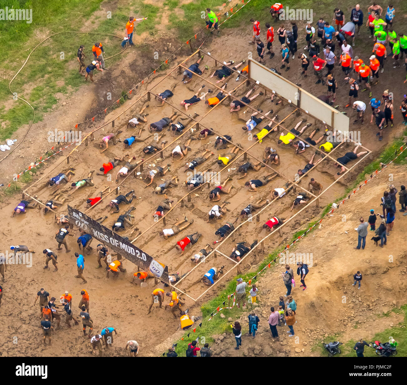 Extreme sports, mud track with barbed wire fence, Tough Mudder - the ultimate mud battle in Sauerland, near Schloss Herdringen, Arnsberg, Sauerland, North Rhine-Westphalia, Germany Stock Photo