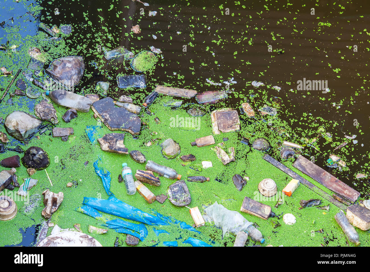 Plastic, bottle ,foam, wood throwing as garbage floating in canal