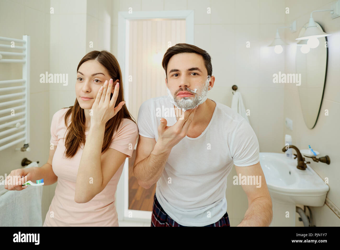 Couple in the morning personal hygiene in the bathroom Stock Photo Alamy