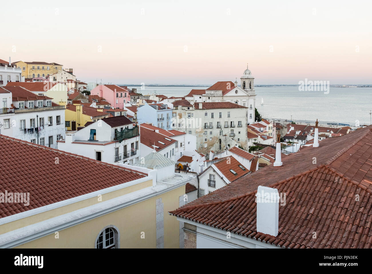 Sunset view of the Alfama district in Lisbon towards the Tagus river from the Miradouro das Sunset view of the Alfama district in Lisbon towards the Tagus river from the Miradouro das