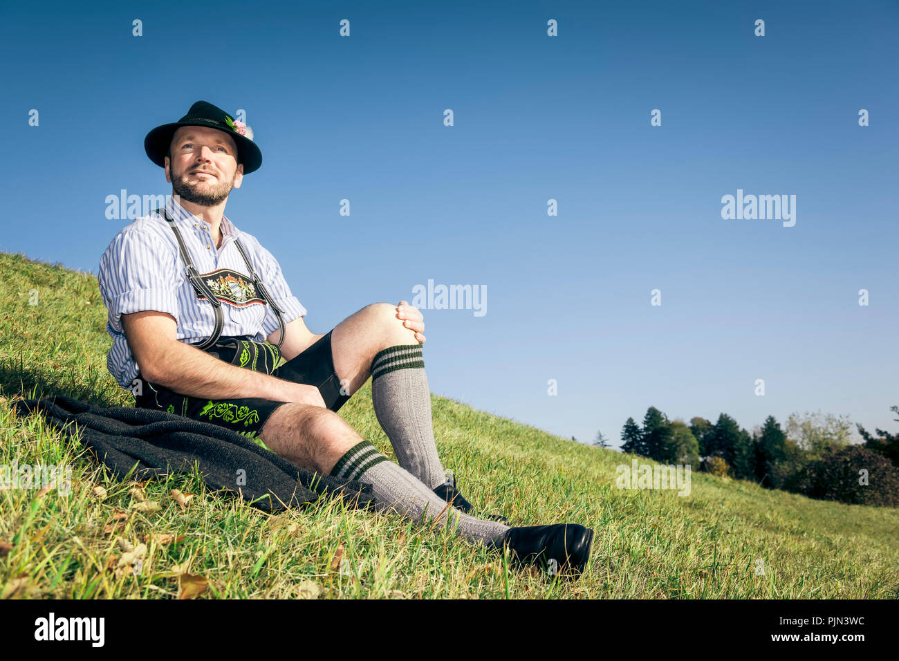 A young man in Bavarian national costume, Ein junger Mann in bayerischer Tracht Stock Photo