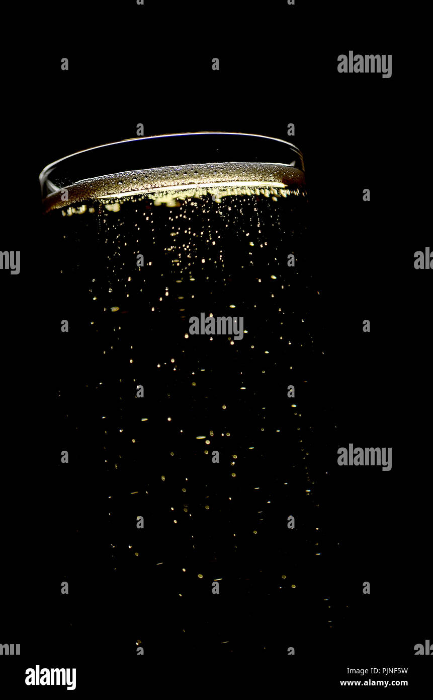 Champagne glass with bubbles on dark background Stock Photo - Alamy