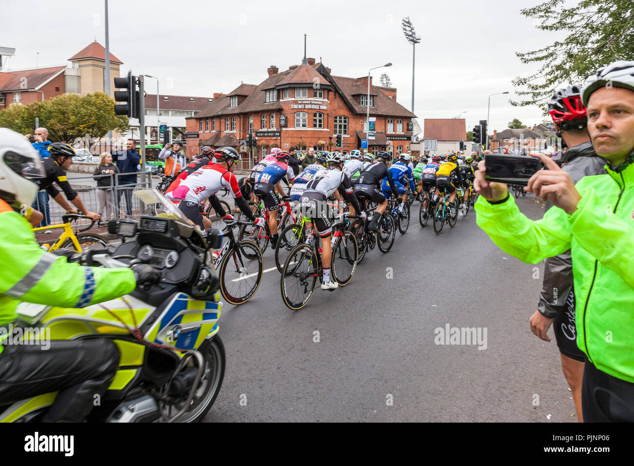 West Bridgford, Nottingham, UK. 8th September 2018. Spectators watch and photograph as the Tour of Britain cycle race passes over Trent Bridge in West Bridgford, Nottingham.  Credit: Martyn Williams/Alamy Live News Stock Photo