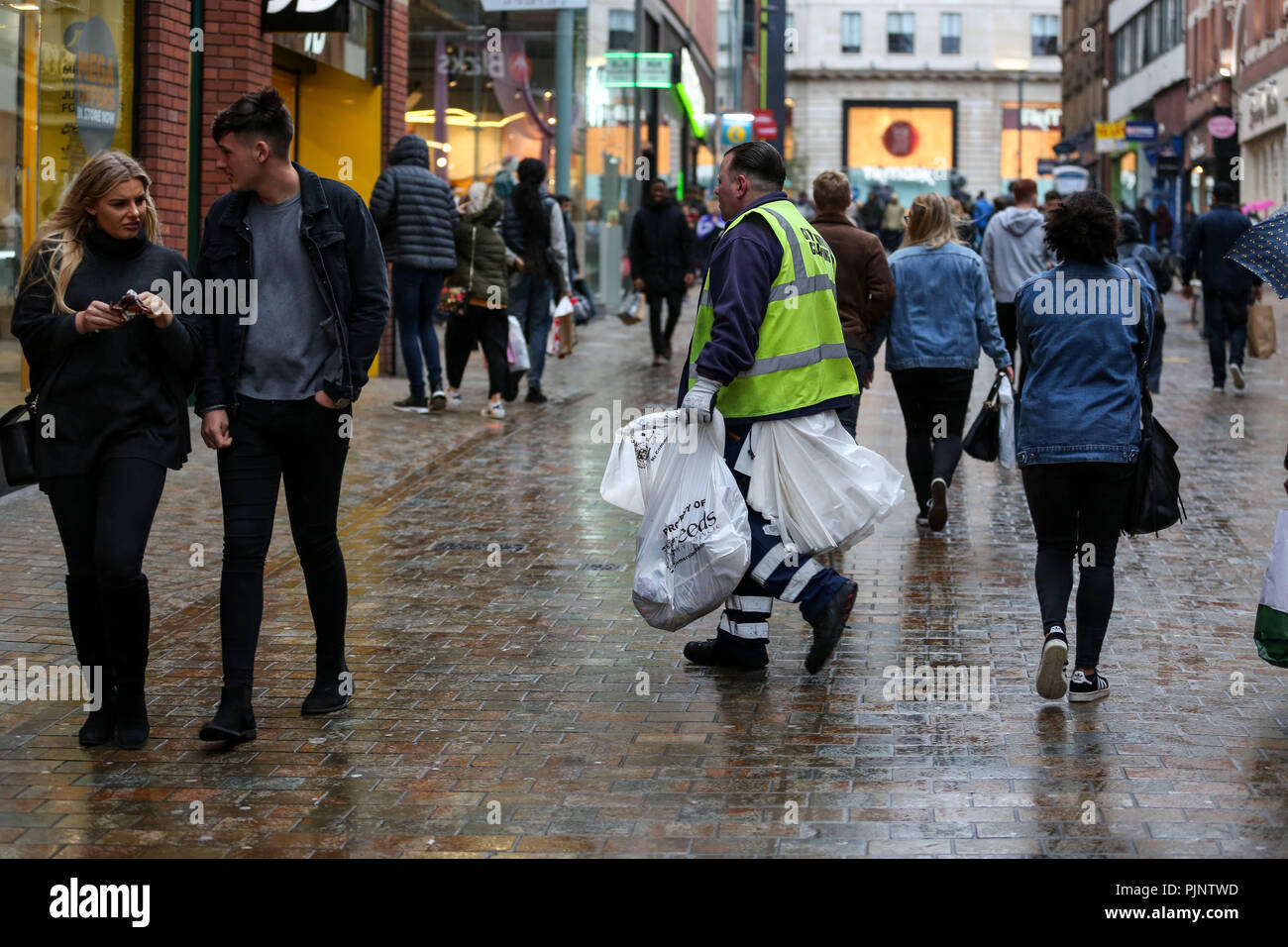 Leeds, UK. 21st Oct, 2017. A street cleaner seen walking in Leeds city  center.Leeds is the largest city in the northern English county of  Yorkshire. It has one of the supreme diverse