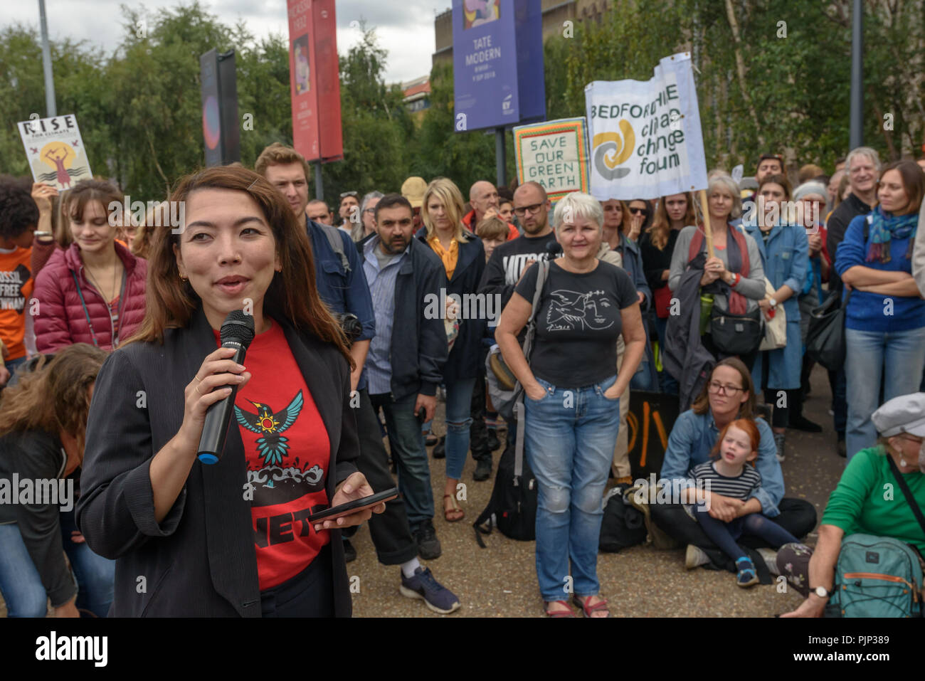 London, UK. 8th September 2018. Hannah Thomas of 350.org speaks at the Climate Reality rally in front of Tate Modern, one of thousands around the world demanding urgent action by government leaders to leaders commit to a fossil free world that works for all of us.  community leaders, organisers, scientists, storytellers a Credit: Peter Marshall/Alamy Live News Stock Photo