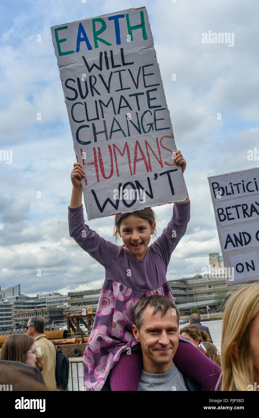 London, UK. 8th September 2018. A young girl on her father's shoulders holds a poster at the Climate Reality rally at Tate Modern, one of thousands around the world demanding urgent action by government leaders to leaders commit to a fossil free world that works for all of us.  community leaders, organisers, scientists, s Credit: Peter Marshall/Alamy Live News Stock Photo