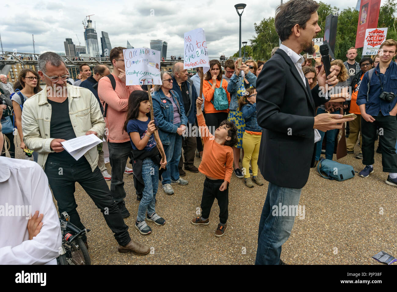 London, UK. 8th September 2018. Adam Woodhall of Inspiring Sustainability speaks at the Climate Reality rally outside Tate Modern, one of thousands around the world demanding urgent action by government leaders to leaders commit to a fossil free world that works for all of us.  community leaders, organisers, scientists, s Credit: Peter Marshall/Alamy Live News Stock Photo