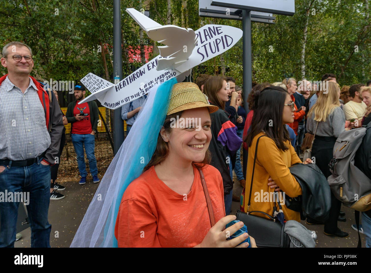London, UK. 8th September 2018. A woman wears a 'Plane Stupid' hat against Heathrow expansion at the Climate Reality  rally in front of Tate Modern, one of thousands around the world demanding urgent action by government leaders to leaders commit to a fossil free world that works for all of us.  community leaders, organis Credit: Peter Marshall/Alamy Live News Stock Photo