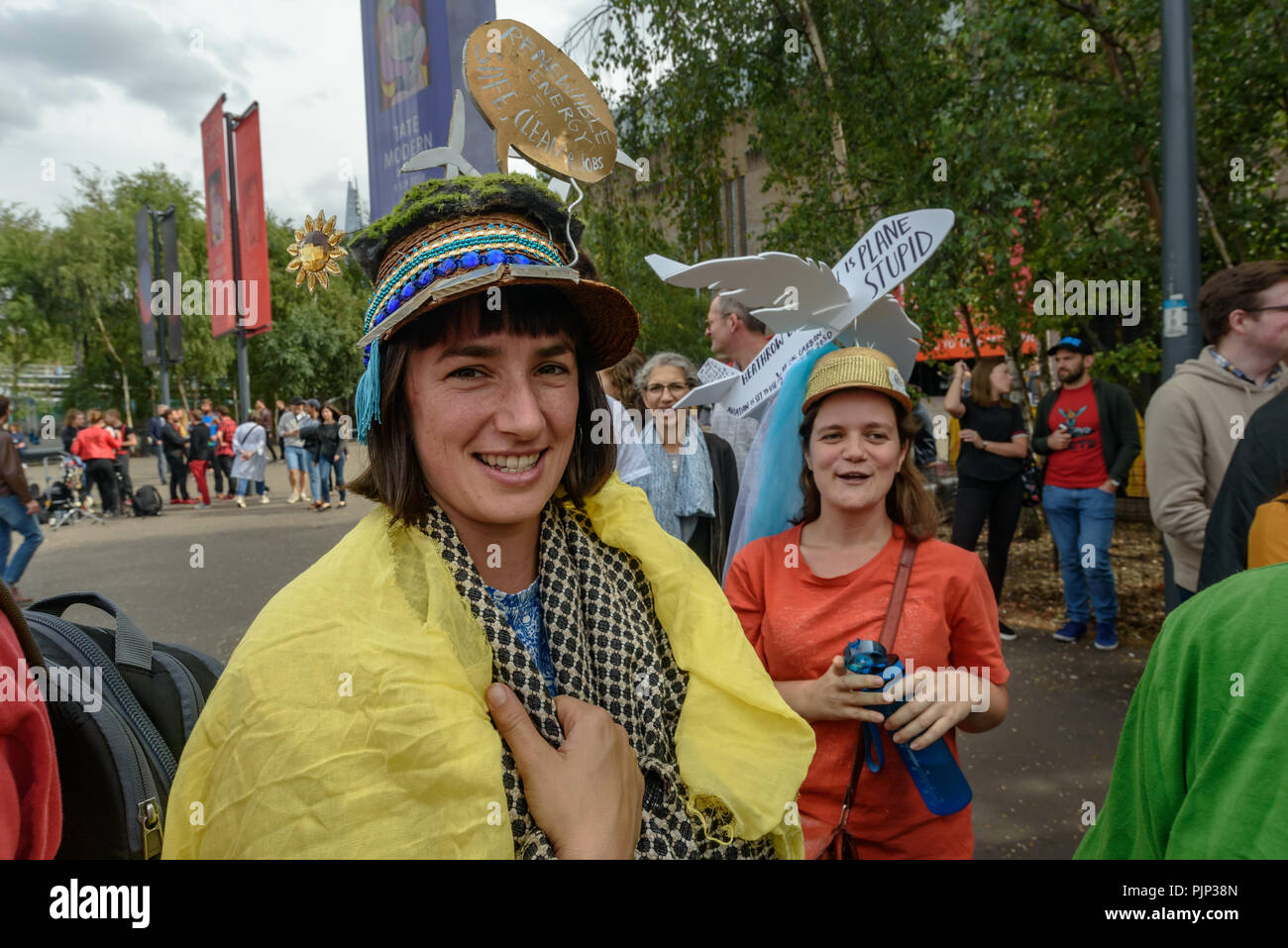 London, UK. 8th September 2018. Climate Reality supporters wear decorated hats at the rally in front of Tate Modern, one of thousands around the world demanding urgent action by government leaders to leaders commit to a fossil free world that works for all of us.  community leaders, organisers, scientists, storytellers an Credit: Peter Marshall/Alamy Live News Stock Photo