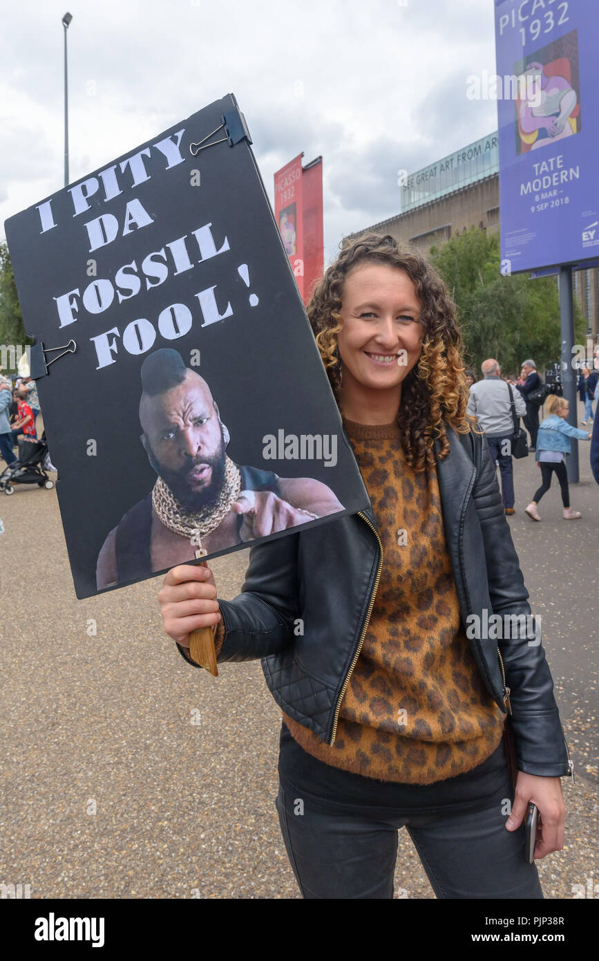 London, UK. 8th September 2018. A woam holds a poster 'I Pity Da Fossil Fool!' at the Climate Reality rally in front of Tate Modern, one of thousands around the world demanding urgent action by government leaders to leaders commit to a fossil free world that works for all of us.  community leaders, organisers, scientists, Credit: Peter Marshall/Alamy Live News Stock Photo