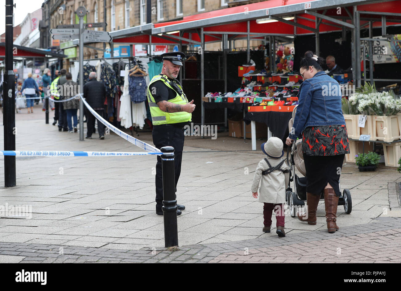 A police officer in Barnsley town centre near the scene of a serious incident. Stock Photo