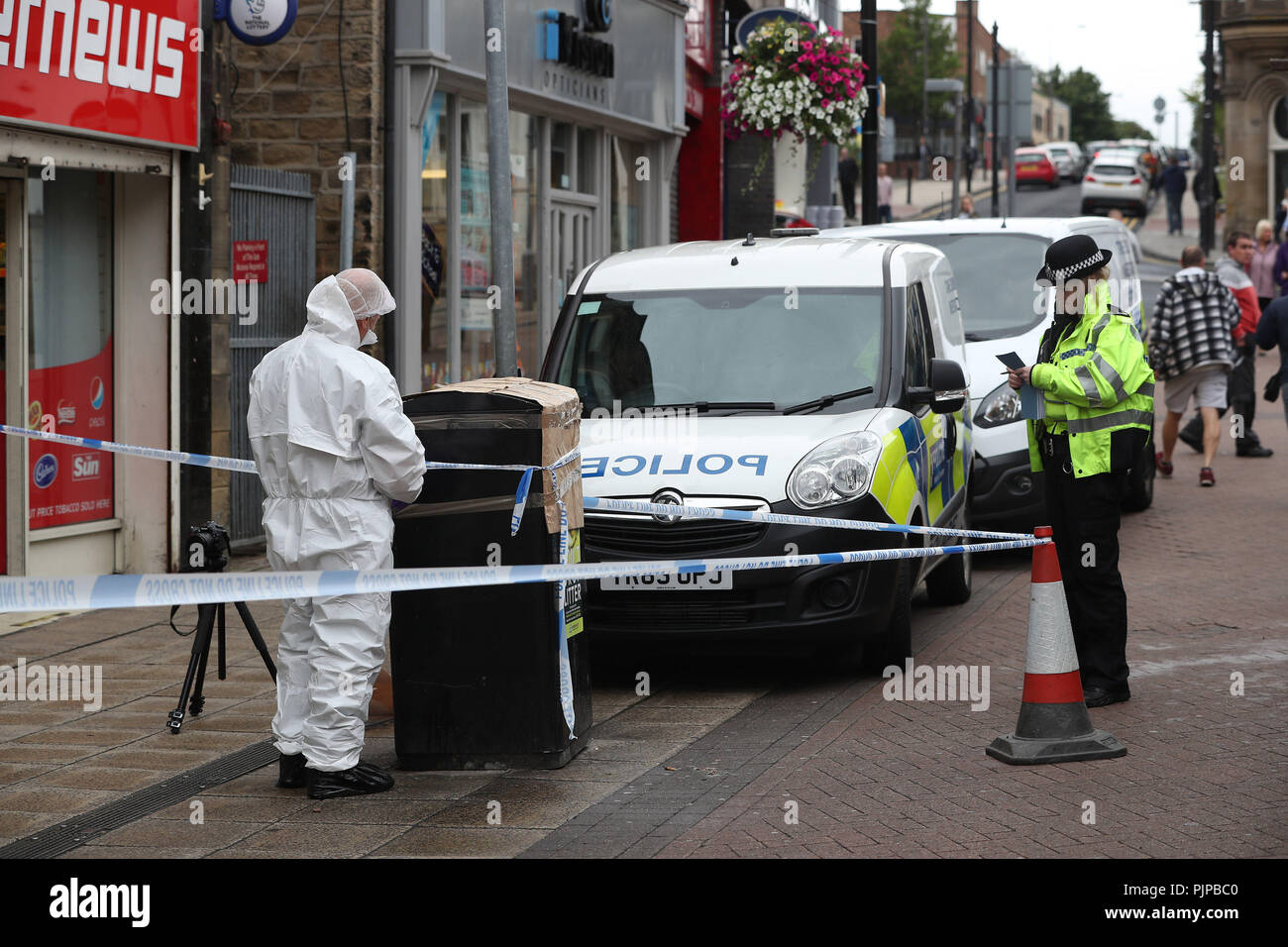 A forensic officer in Peel Square in Barnsley town centre after a serious incident. Stock Photo