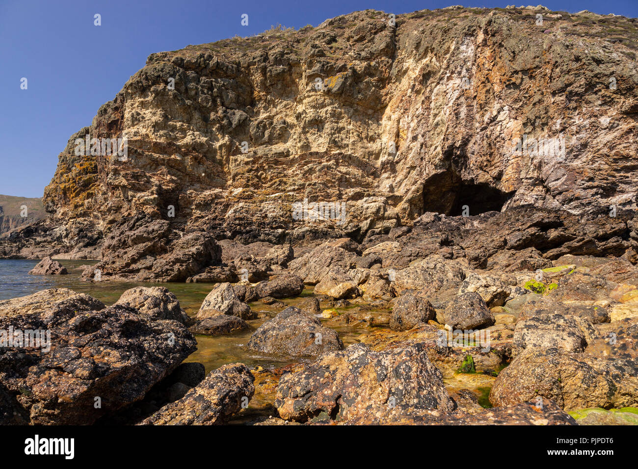 Cliffs and cave at Ynys-y-Fydlyn on the coast of Anglesey, North Wales Stock Photo