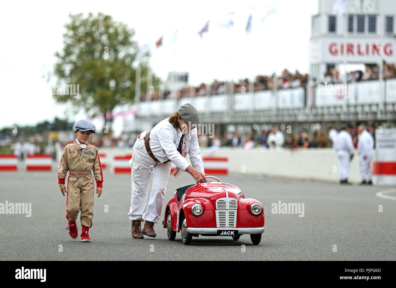 A competitor makes his way to the start line in The Settrington Cup on day two of the Goodwood Revival at the Goodwood Motor Circuit, in Chichester. Stock Photo