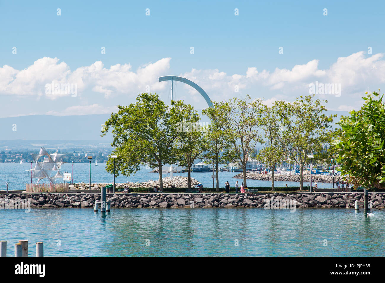View of Lausanne Ouchy port, Switzerland on Lake Leman (Geneva Lake) on sunny summer day with blue sky and white clouds Stock Photo