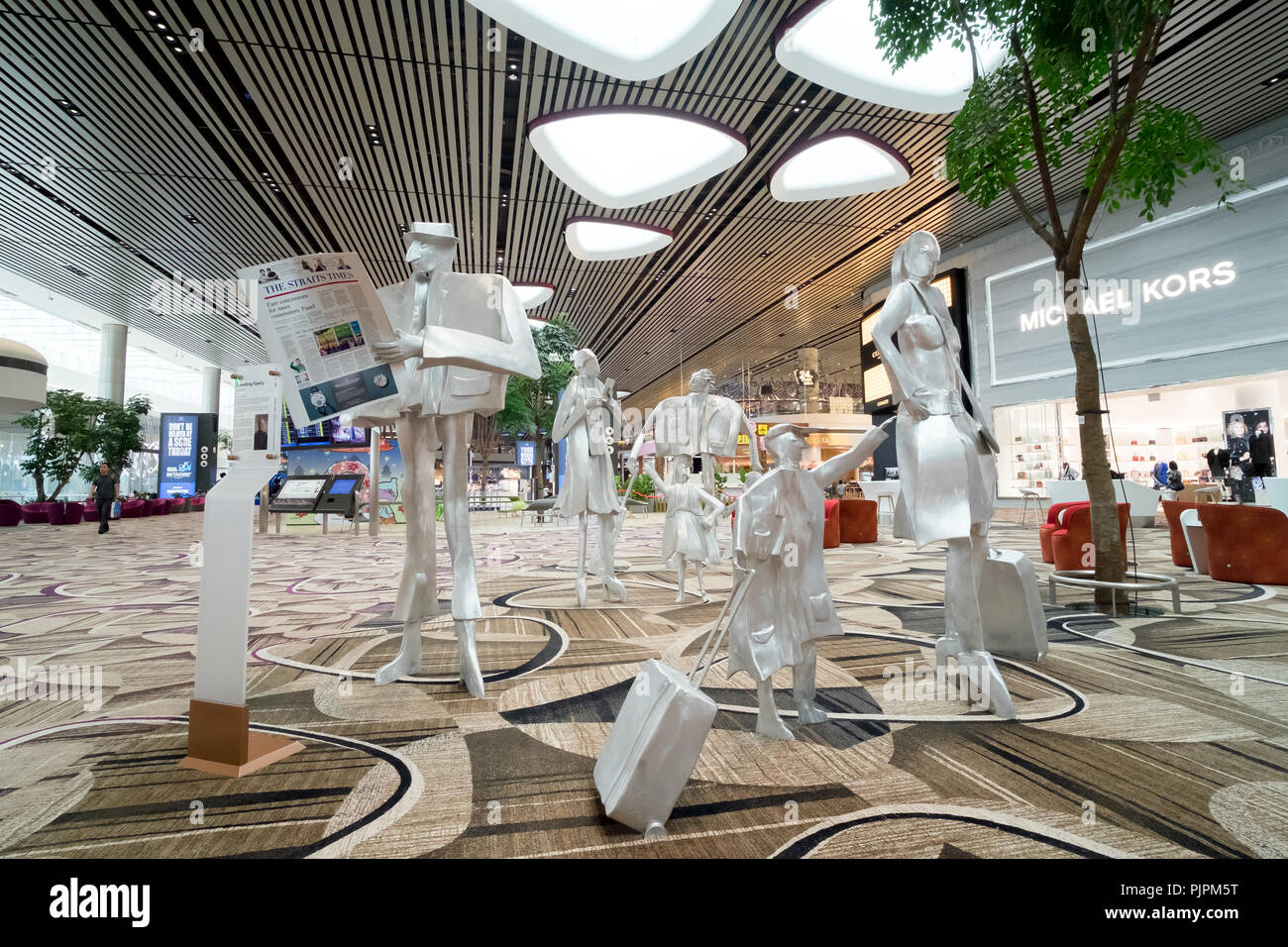 Changi Airport, Singapore - 2017,November 12th: The silver statues of Travelling Family by inside Kurt Metzier at Departure Transit Central Area in Te Stock Photo