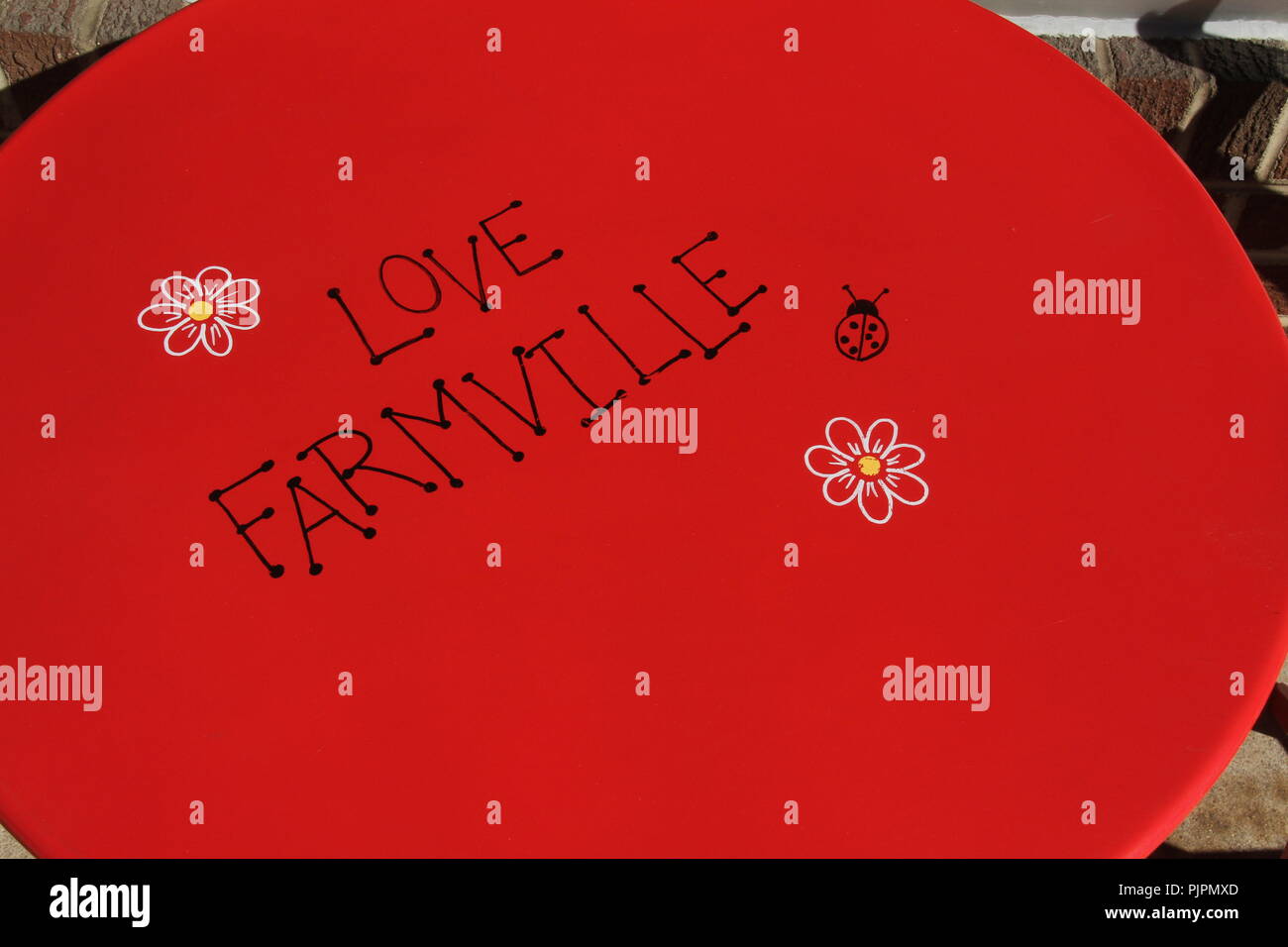 "Love Farmville" message on table outside small business in downtown Farmville, Virginia Stock Photo