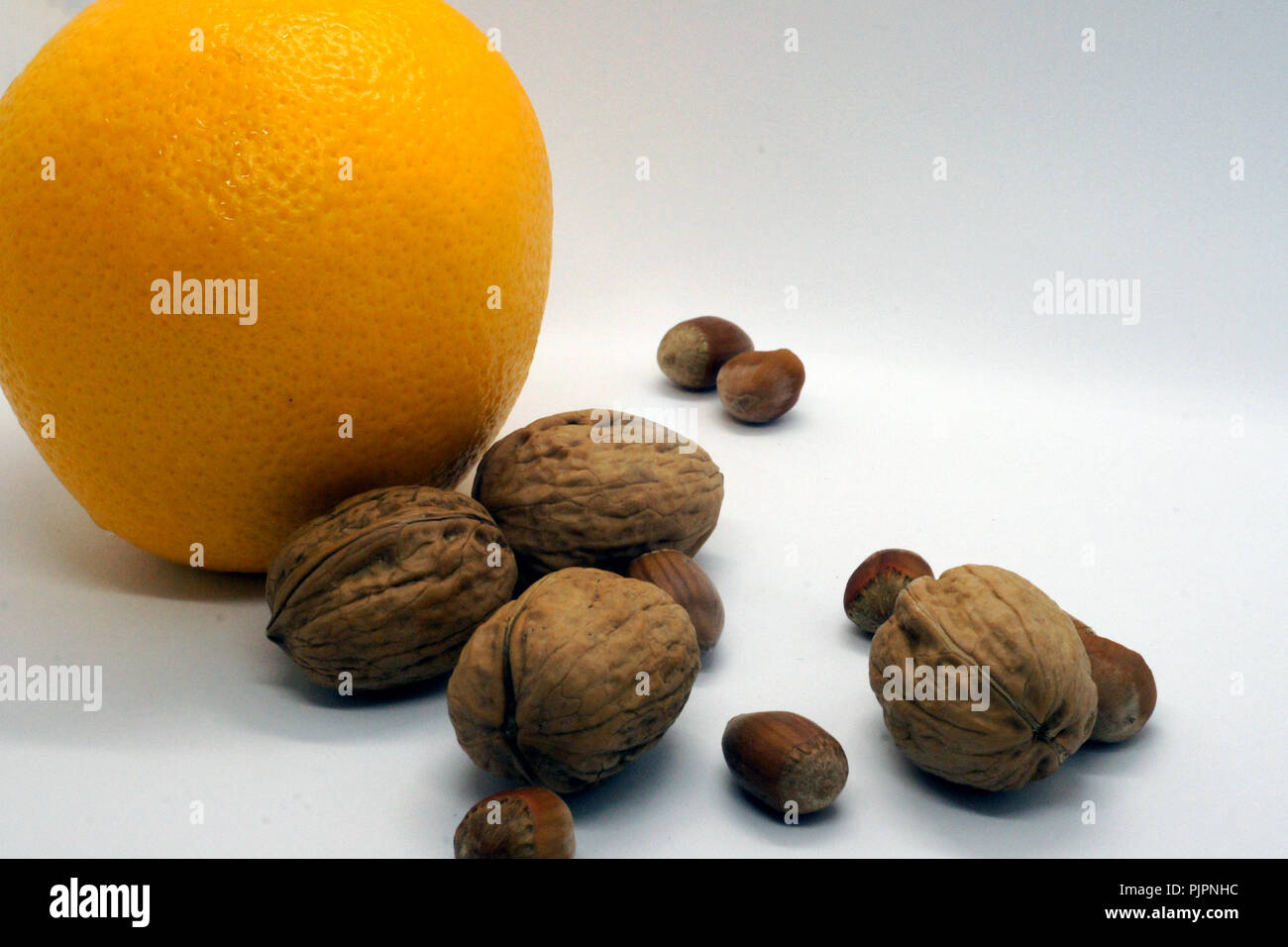 walnuts hazelnuts and orange Stock Photo