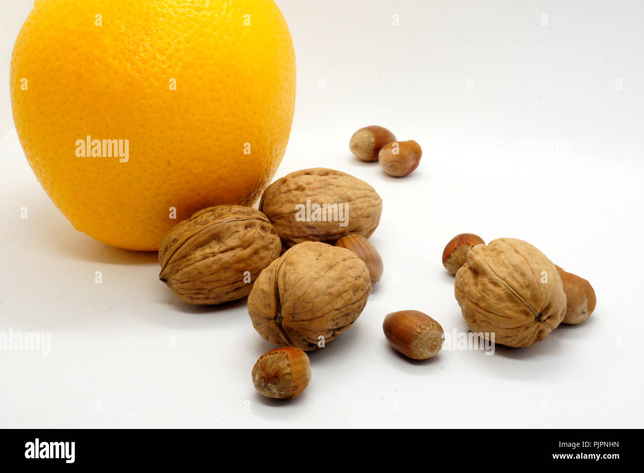 walnuts hazelnuts and orange Stock Photo