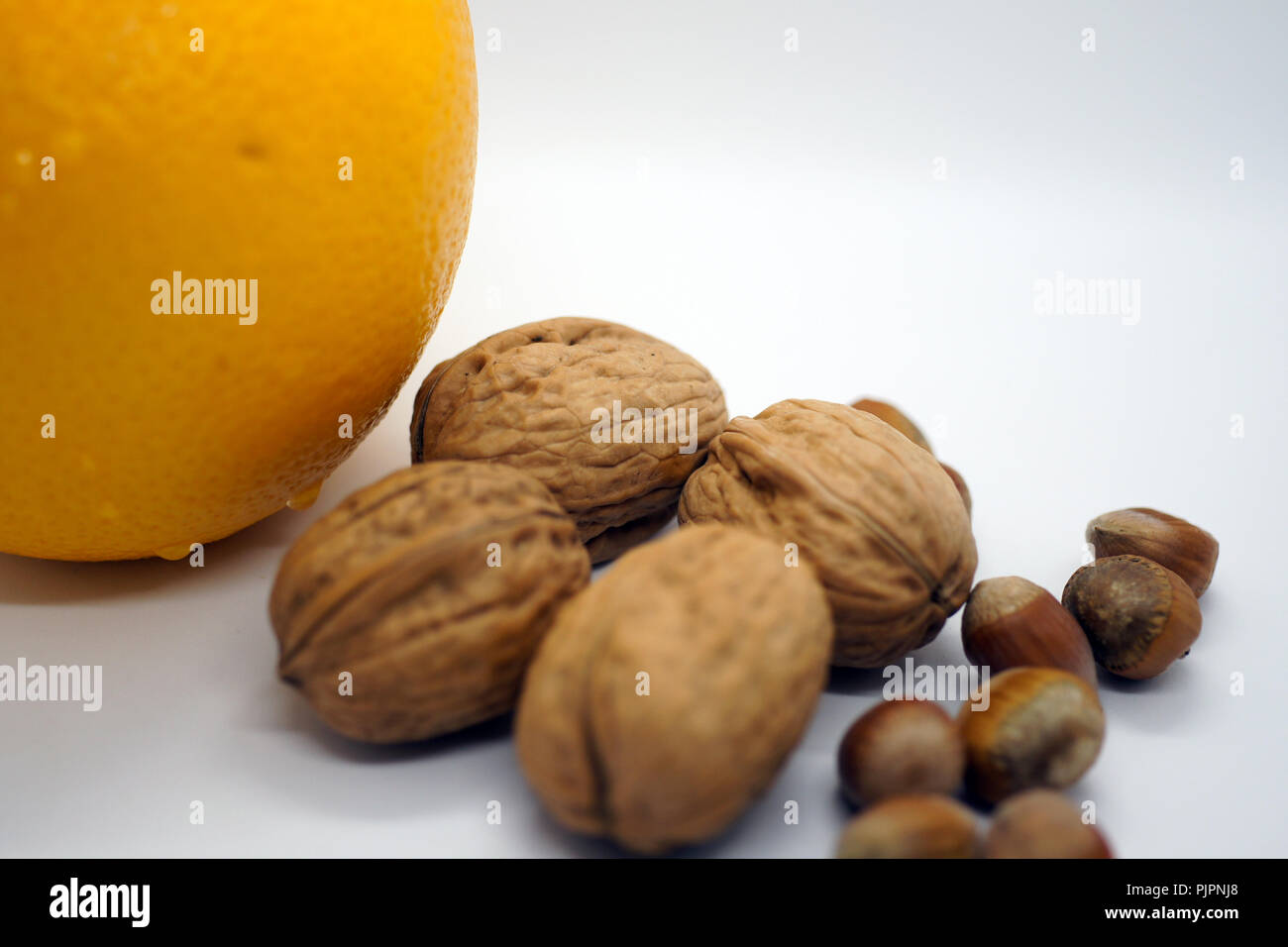 walnuts hazelnuts and orange Stock Photo