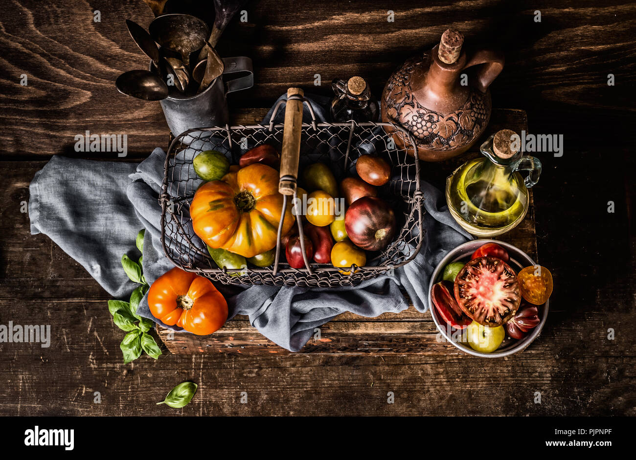 Colorful ,organic ,tomatoes, harvest ,basket , dark, rustic ,kitchen, table , cooking, ingredients,Healthy, food ,concept Stock Photo