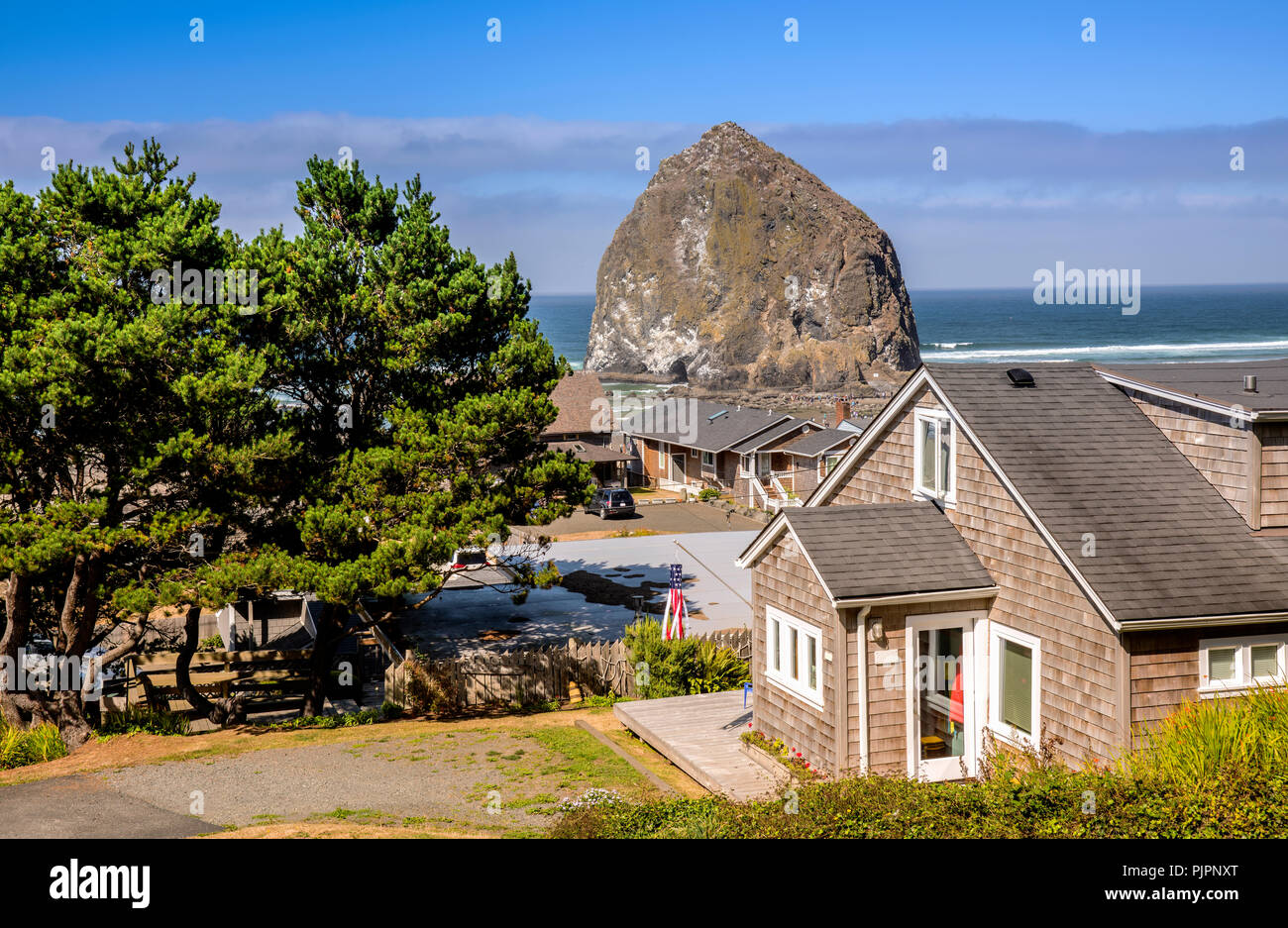 Canon beach township and haystack rock Oregon coast Stock Photo - Alamy