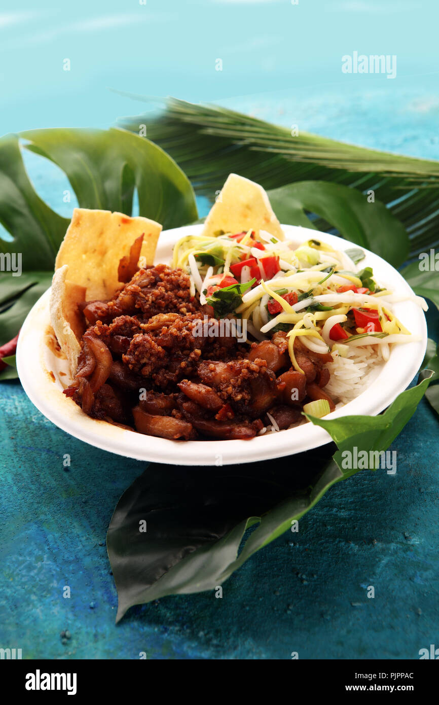 Nasi Campur Bali. Popular Balinese meal of rice with meat. Typical Malaysian street food lunch mixed rice Stock Photo