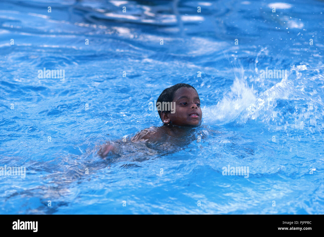 Young boy swimming Stock Photo