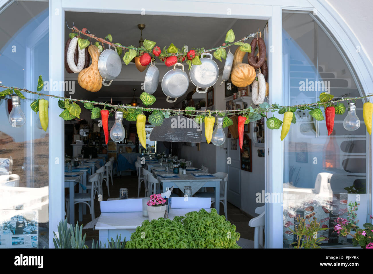 Traditional Greek shop with different food and taverna in Thira town. Thira town is the capital of Santorini island. Stock Photo