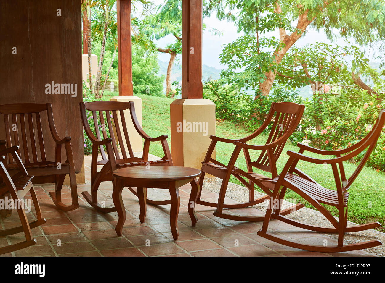 Patio with wooden chairs and table on summer sunny background Stock Photo